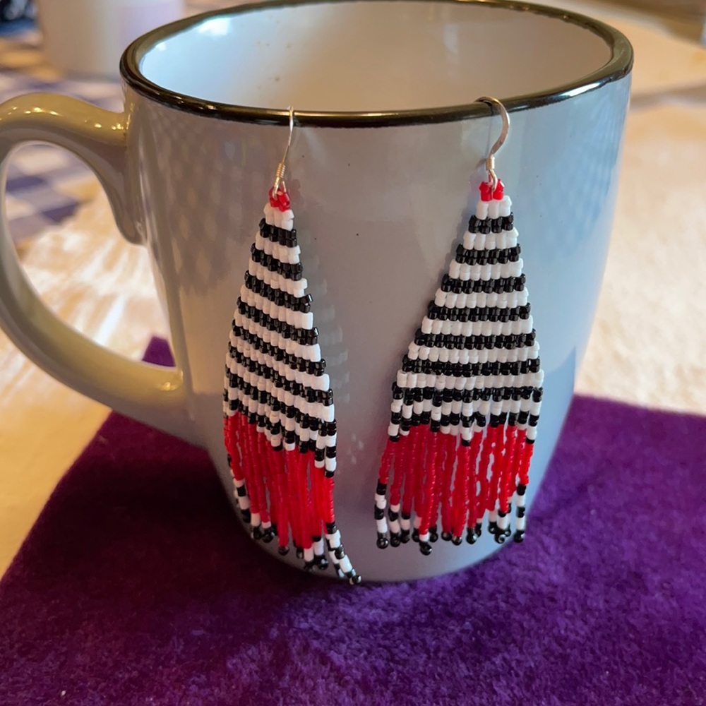 Hand beaded fringe earrings.